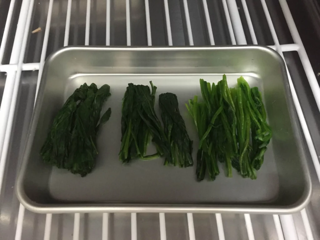 Spinach frozen on a tray