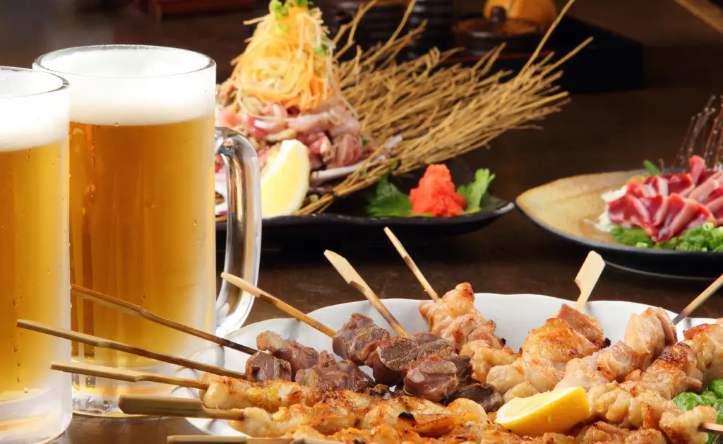 Beer mug, yakitori and sashimi